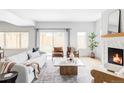 Bright living room featuring hardwood floors, modern furniture, and a cozy fireplace at 108 Arapahoe St, Golden, CO 80403