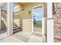 Condo entrance featuring a glass door and access to a staircase, unit number D14 at 6013 Castlegate W Dr # D14, Castle Rock, CO 80108