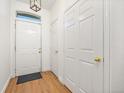 Bright entryway with hardwood floors and white doors to a closet at 6013 Castlegate W Dr # D14, Castle Rock, CO 80108