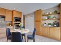 Cozy dining area with a round table, stylish chairs, built-in cabinets and display shelves at 6495 E Happy Canyon Rd # 22, Denver, CO 80237