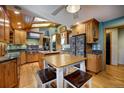 Bright kitchen featuring custom wood cabinets, granite countertops, stainless steel appliances and eat-in table at 207 County Road 65, Evergreen, CO 80439