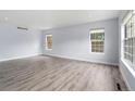 Bright living room with large windows, neutral walls, and light-colored wood flooring at 9451 W Hialeah Pl, Littleton, CO 80123