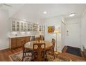 Charming kitchen with wood cabinets, farmhouse sink, recessed lighting, and adjacent dining area at 705 S Alton Way # 4D, Denver, CO 80247