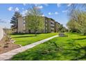 A charming apartment complex with well-manicured lawns and a bench, offering a serene outdoor setting at 655 S Alton Way # 8D, Denver, CO 80247