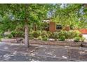 Quaint brick home framed by mature shade trees at 3044 W 40Th Ave, Denver, CO 80211