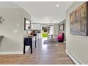 Dining area adjacent to the kitchen, filled with natural light and a retro booth at 16816 E Costilla Ave, Foxfield, CO 80016