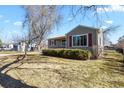 Attractive home featuring a lush lawn and mature trees, providing a serene and welcoming atmosphere at 4546 S Logan St, Englewood, CO 80113