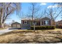 Charming home with a well-manicured front yard and inviting facade, with a detached garage at 4546 S Logan St, Englewood, CO 80113