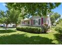 Quaint single-story home with manicured lawn and mature landscaping at 4546 S Logan St, Englewood, CO 80113