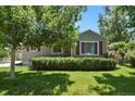 Charming home featuring a well-maintained lawn, mature trees, and a welcoming facade at 4546 S Logan St, Englewood, CO 80113