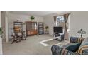 Comfortable living room featuring neutral carpeting, large windows, and traditional furnishings at 4546 S Logan St, Englewood, CO 80113