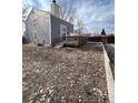 A serene backyard featuring a well-maintained deck, offering a private outdoor space, surrounded by a leafy ground cover at 11449 E 1St Ave, Aurora, CO 80010