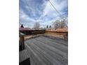A weathered wooden deck with wood railing, perfect for enjoying the backyard scenery and outdoor living at 11449 E 1St Ave, Aurora, CO 80010