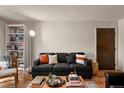 Comfortable living room features a sofa, stylish decor, and wood flooring at 8555 Fairmount Dr # G208, Denver, CO 80247