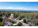 Beautiful aerial view of a home, community, green space, and the rocky mountains in the background at 2539 Lake Meadow Dr, Lafayette, CO 80026
