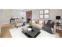 Nicely furnished living room with hardwood floors, fireplace, sofa, chair and accent table at 6490 S Dayton St # L02, Englewood, CO 80111