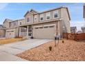 Well-manicured front yard highlighting the home's curb appeal and showcasing a two-car garage at 857 Gold Hill Dr, Erie, CO 80516