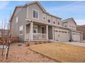 Attractive exterior view of a two-story home featuring a welcoming front porch and low maintenance landscaping at 857 Gold Hill Dr, Erie, CO 80516