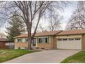 Charming ranch-style home featuring a two-car garage, and landscaped front yard at 12286 W Tennessee Ave, Lakewood, CO 80228