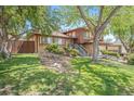 Charming two-story home with brick and siding, well-maintained landscaping, and mature shade trees at 12289 W Atlantic Ave, Lakewood, CO 80228