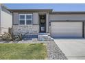 Charming single-Gathering home featuring a two-car garage, manicured lawn, and inviting front entrance at 13460 Broad Wing Ave, Parker, CO 80134