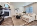 Beautiful living room with a fireplace, large sectional sofa, and contemporary decor at 13460 Broad Wing Ave, Parker, CO 80134