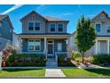 Two-story craftsman home with welcoming front porch at 8668 E 54Th Pl, Denver, CO 80238