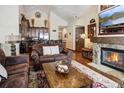 Inviting living room featuring a stone fireplace, wood floors, and adjacent kitchen at 680 S Main St # 18, Breckenridge, CO 80424