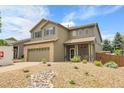 Beautiful two-story home with a brick-accented garage, charming front porch and rock landscaping at 10540 Tracewood Cir, Highlands Ranch, CO 80130