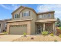 Inviting two-story home boasts a well-manicured front yard and a cozy covered porch at 10540 Tracewood Cir, Highlands Ranch, CO 80130
