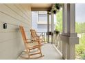 Inviting porch with rocking chairs, hanging plants and great curb appeal at 10540 Tracewood Cir, Highlands Ranch, CO 80130