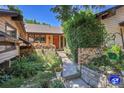 Inviting front entrance with beautiful landscaping, a brick walkway, and charming flower boxes, creating a warm welcome at 4901 W 103Rd Cir, Westminster, CO 80031