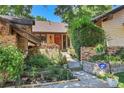 Inviting front entrance with beautiful landscaping, a brick walkway, and charming flower boxes, creating a warm welcome at 4901 W 103Rd Cir, Westminster, CO 80031