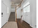 Entryway with ceramic tile, closet, hardwood flooring and a staircase leading upstairs at 1623 E 164Th Pl, Brighton, CO 80602