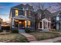 Beautiful home featuring a covered front porch, exterior lighting, and a well-kept lawn at 713 S Washington St, Denver, CO 80209