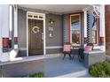 Close-up of a cozy front porch with seating and stylish brickwork at 713 S Washington St, Denver, CO 80209