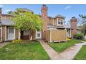 Charming townhouse with a brick chimney and a well-manicured front yard at 14231 E Dickinson Dr # E, Aurora, CO 80014