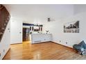 Open-concept living area with hardwood floors connecting to a modern kitchen at 14231 E Dickinson Dr # E, Aurora, CO 80014