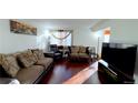 Bright living room featuring hardwood floors and ample seating at 2683 S Carson Way, Aurora, CO 80014