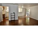 Bright living room featuring hardwood floors and natural light, flowing into the adjacent kitchen at 12512 E Cornell Ave # 101, Aurora, CO 80014