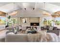 Cozy living room with stone fireplace, vaulted ceilings, and comfortable seating at 4 Greenridge Rd, Greenwood Village, CO 80111