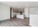 Bright open-concept kitchen featuring hardwood floors and island at 14109 Deertrack Ln, Parker, CO 80134