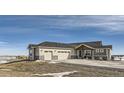 Ranch style home with three car garage and inviting front porch at 229 High Meadows Loop, Elizabeth, CO 80107