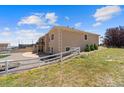 Spacious backyard with a white fence, a deck, and mature landscaping at 38087 E 147Th Pl, Keenesburg, CO 80643