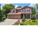 Beautiful two-story home with a two-car garage, stone accents, and a landscaped front yard at 2521 Otter Ct, Lafayette, CO 80026