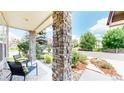 Inviting front porch with stone pillars and seating, offering a cozy outdoor space at 2521 Otter Ct, Lafayette, CO 80026