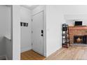 Open-concept entryway with hardwood floors and a wood-burning fireplace at 14206 E 1St Dr # B10, Aurora, CO 80011