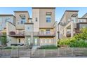 Contemporary townhomes with fenced yards, balconies, and modern architectural elements at 5668 Galena St, Denver, CO 80238