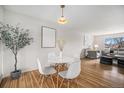 Cozy dining area with modern white table and chairs, hardwood floors, and a bright, airy ambiance at 1529 Ashcroft Dr, Longmont, CO 80501