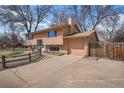 Two-story home featuring a two-car garage, concrete driveway, and fenced backyard at 1529 Ashcroft Dr, Longmont, CO 80501